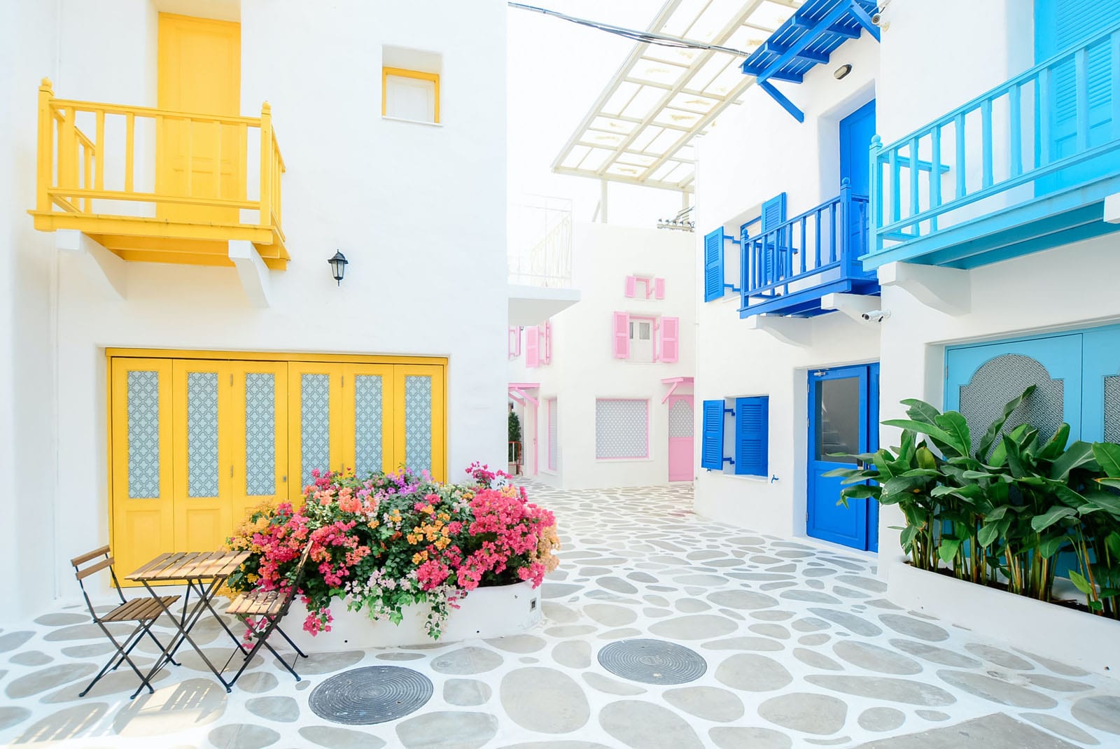 pexels-tirachard-kumtanom-347141 Brightly coloured courtyard with table and chairs